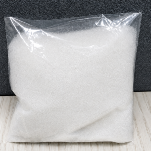 Pure off white crystalline extract powder inside a transparent plastic pouch